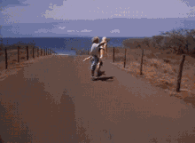 a man is holding a gun in front of a white car