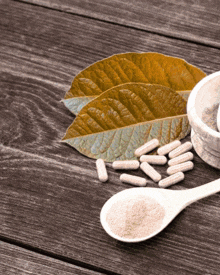 a wooden table with a mortar and pestle filled with pills