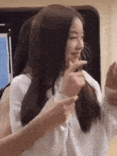 a woman with long hair is holding another woman 's hair .