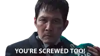 a man in a suit and tie is holding a green shirt that says 450 on it