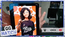 a person is holding a tablet with a picture of a girl and the words gg match on it