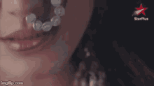 a close up of a woman 's face with a star plus logo