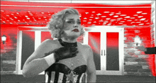 a woman in a corset and gloves stands in front of a red door