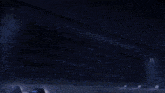 a person is standing in a dark room with a light coming out of the door .