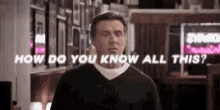 a man in a black sweater is standing in front of a sign that says `` how do you know all this ? ''