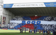 a soccer field with a banner that says ' r000 ' on it