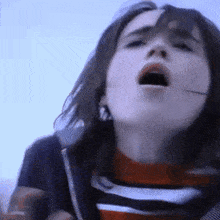 a close up of a girl with her mouth open