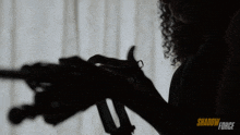 a woman is holding a gun in front of a window with shadow force written on the bottom