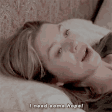 a woman laying on a bed with the words i need some hope written below her