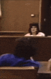 a blurred image of a person sitting in a chair