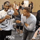 a group of people are playing a game with the hashtag #slc on the bottom