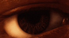 a close up of a person 's eye with a glowing light in it