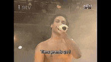 a shirtless man is singing into a microphone with the words tiens prends ca written below him