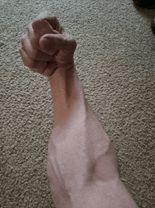 a man 's arm with a fist in it