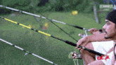 a man is holding a fishing rod in front of a screen that says astro citra