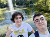 two young men are posing for a picture with one wearing a t-shirt that says ' memby 32 zatitos '