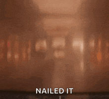 a man is laying on a table with the words `` nailed it '' written on the bottom .