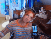 a woman wearing headphones sitting in front of a microphone in a living room .