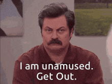 a man with a mustache is saying " i am unamused. get out "