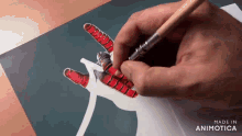 a person is drawing a spiderman hand with a brush