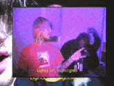 a man in a red shirt that says lights off nightlights on it