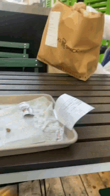 a bag that says ' shack ' on it is on a wooden table