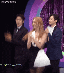 a group of people are standing next to each other on a stage .