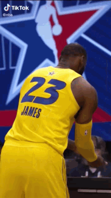 lebron james is wearing a yellow jersey with the number 23 on the back