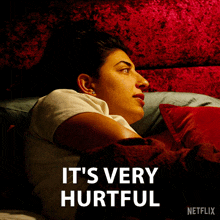 a woman laying on a bed with the words " it 's very hurtful " on the bottom