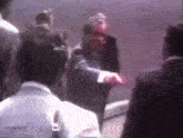 a man in a suit is talking to another man in a white shirt with the words watergate on the bottom