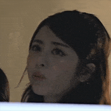 a close up of a woman 's face with her eyes closed