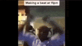 a person is making a beat at 11pm in a video .
