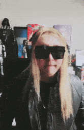 a woman wearing sunglasses and a leather jacket