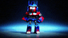 a toy robot is standing on a blue surface with a black background .