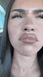 a close up of a woman making a face with her mouth open