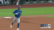 a baseball player for the blue jays runs to first base