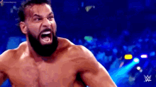 a shirtless wrestler with a beard is screaming with his mouth open