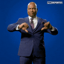 a man in a suit and tie is making a thumbs down sign