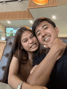 a man and a woman are posing for a picture together