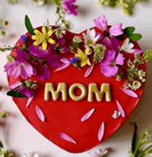 a heart shaped cake with the word mom written on it