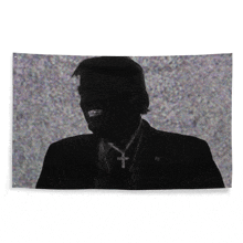 a silhouette of a man in a suit and tie with a cross necklace