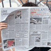 a woman is reading a newspaper that says love language
