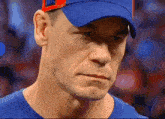 a close up of a man wearing a blue shirt and a blue hat that says phillies on it