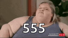 a very fat woman is sitting on a couch .
