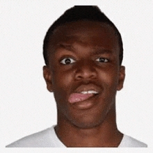 a man is sticking his tongue out while making a funny face .