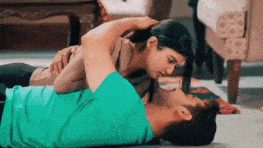 a man and a woman kissing on the floor