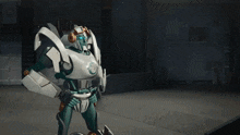 two robots are standing next to each other and one has a red wing