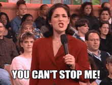 a woman speaking into a microphone with the words you can 't stop me behind her