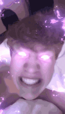 a close up of a person 's face with glowing pink eyes