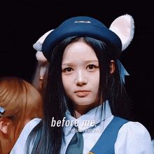 a girl wearing a hat with ears and the words before me
